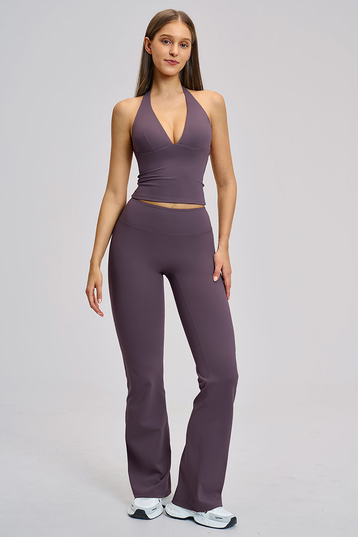 Women's two-piece athleisure workout set in purple: halter V-neck top and flared leggings