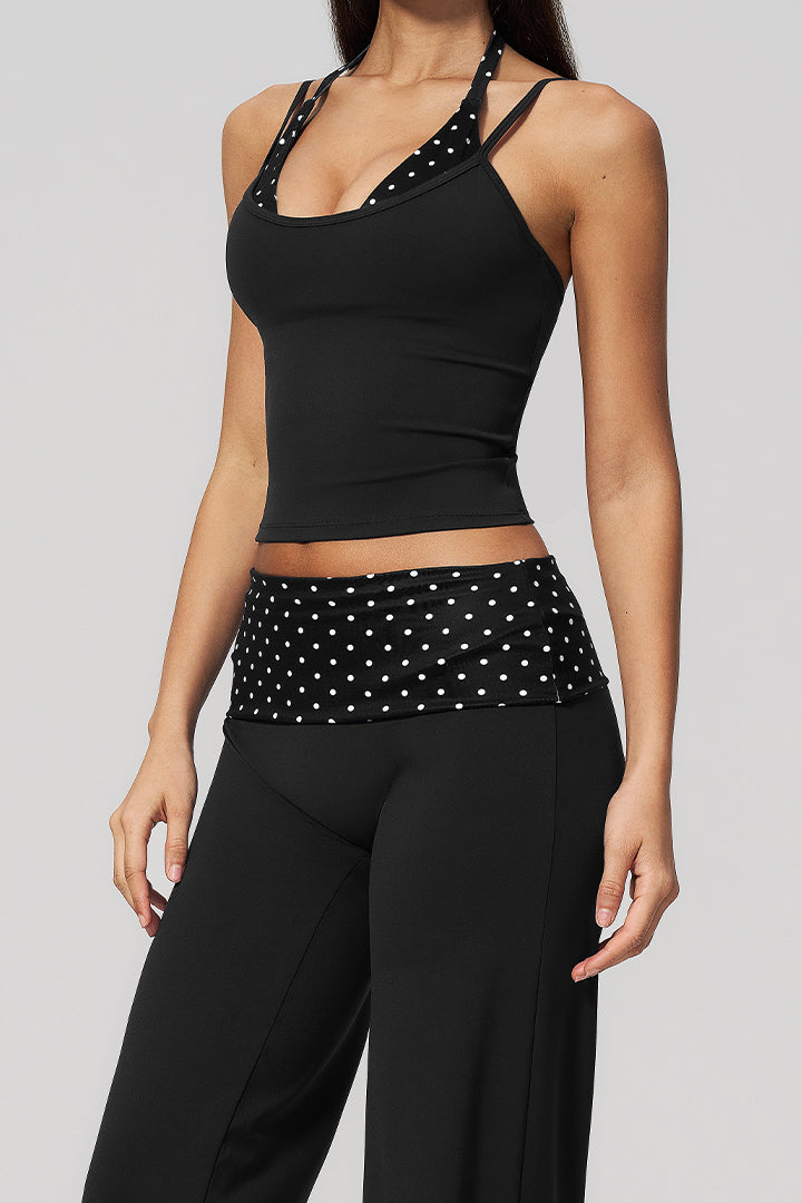 Black halter top with polka-dot trim and black wide-leg pants with ruched waist