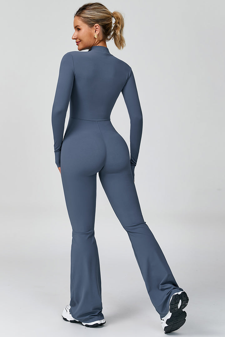 Blue women's long-sleeve sports jumpsuit, back view with flared pant legs