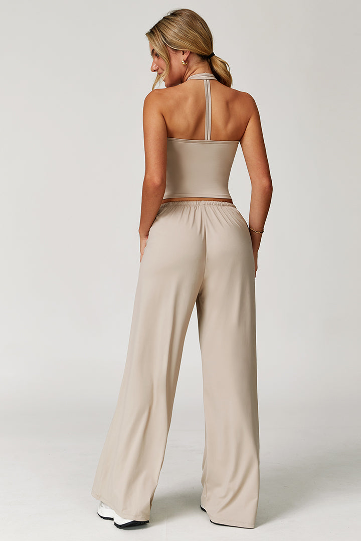 Cream two-piece athleisure set, open-back tank and wide-leg joggers