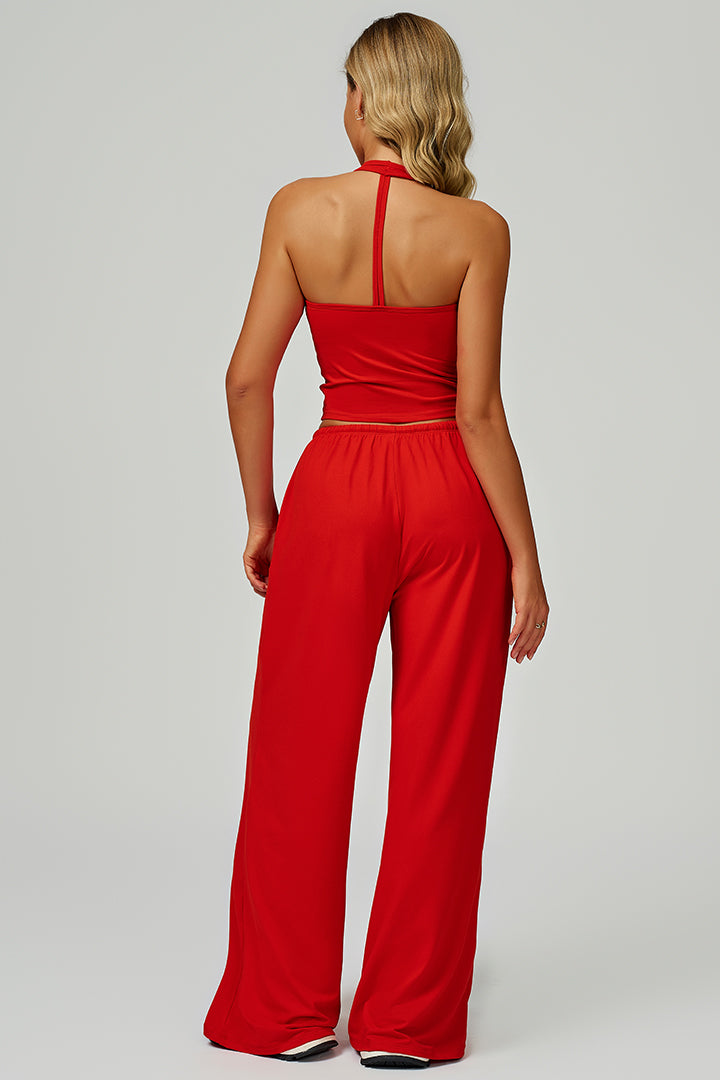 Red two-piece athleisure set with open-back tank and wide-leg joggers, back view
