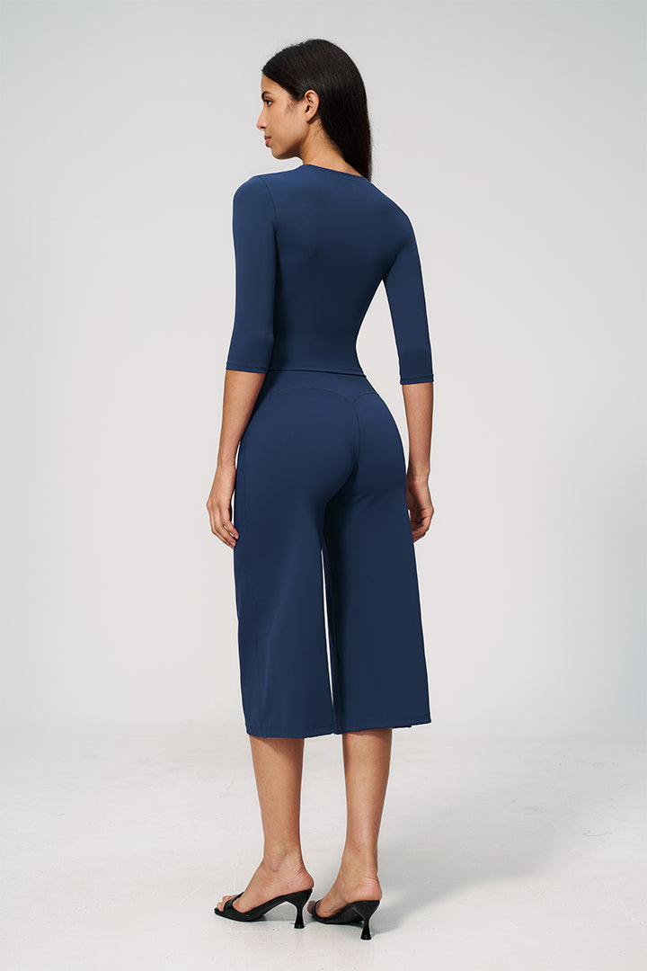 Blue 2-piece set from back view: fitted crop top and wide-leg capri pants