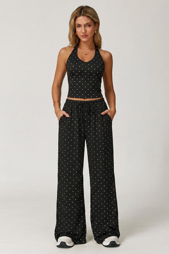 Black polka-dot sleeveless crop top with wide-leg trousers and drawstring waist