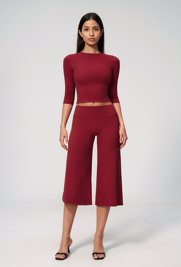 Burgundy two-piece set with long-sleeve cropped top and wide-leg capri pants