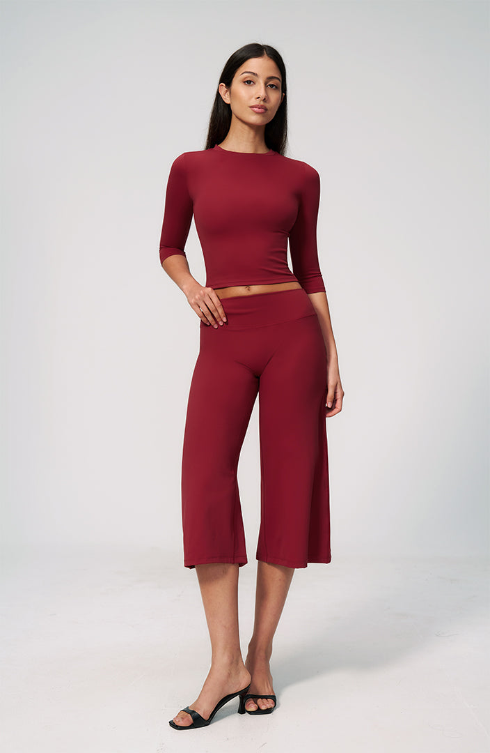 Burgundy two-piece set with long-sleeve cropped top and wide-leg capri pants