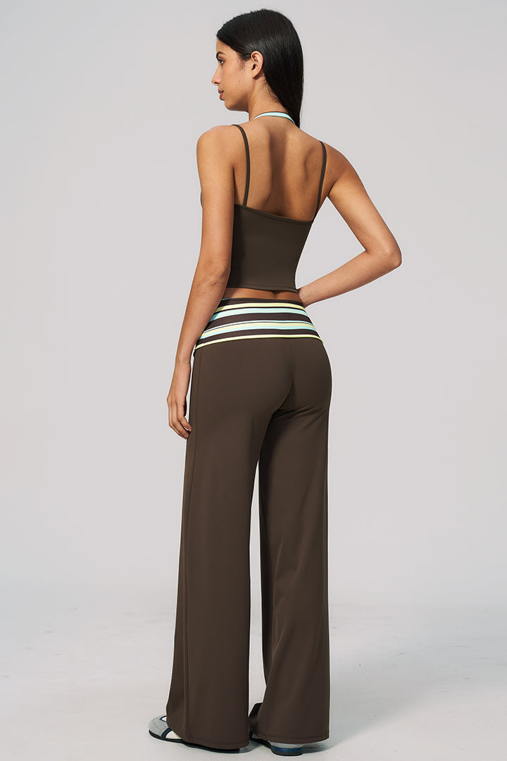 Back view: black halter crop top with striped waistband and wide-leg pants set
