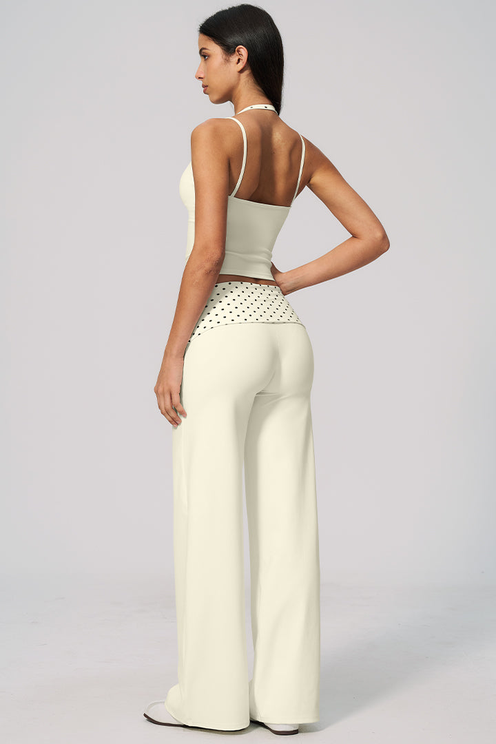 Back view: cream halter crop top with polka-dot waistband and wide-leg pants set