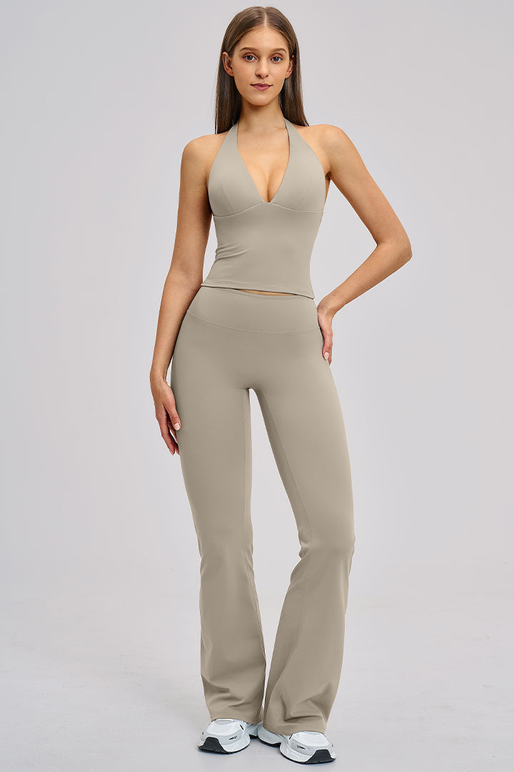 Women's athleisure set in taupe gray: halter V-neck crop top with flared leggings.