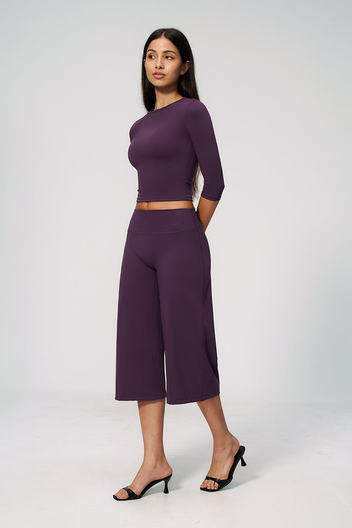 Purple two-piece set with long-sleeve cropped top and wide-leg capri pants