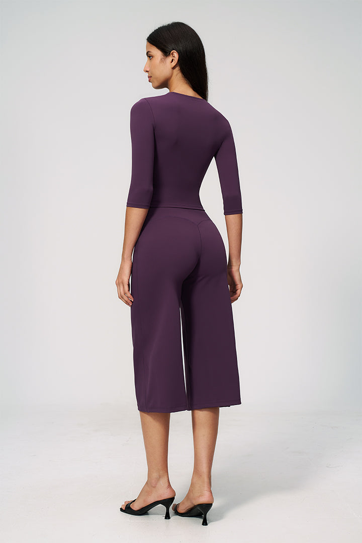 Purple two-piece set with long-sleeve cropped top and wide-leg capri pants, back view