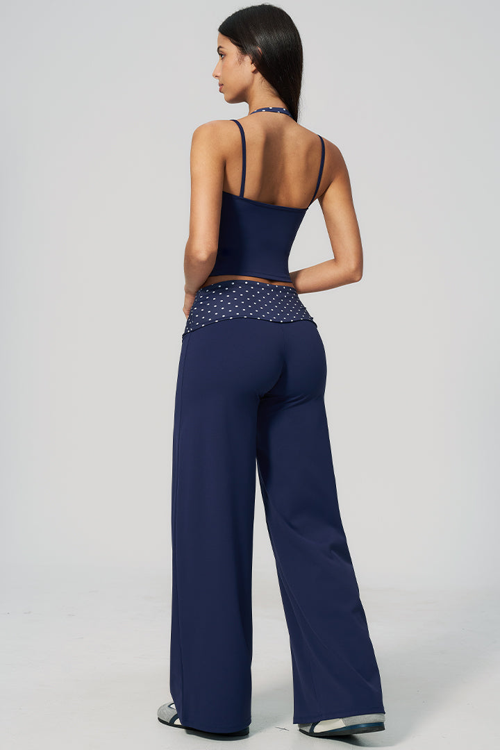 Back view of navy halter top and wide-leg pants set with polka-dot waist trim