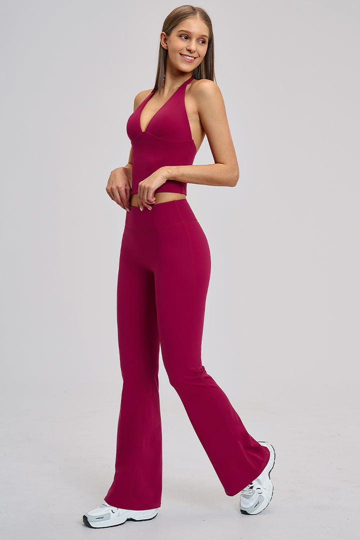 Women's two-piece athleisure workout set in raspberry red: halter V-neck tank and flared leggings