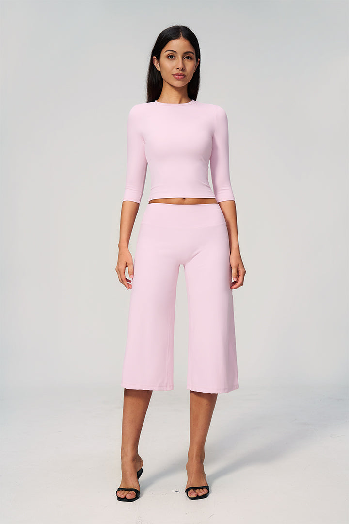 Light pink two-piece set with long-sleeve cropped top and wide-leg capri pants