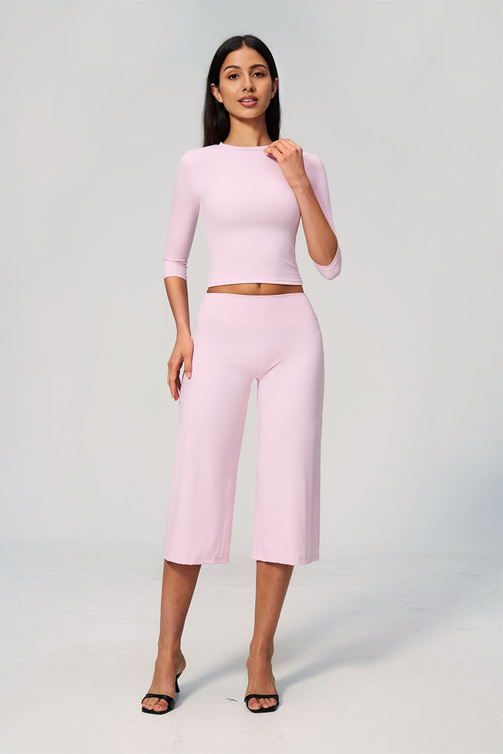 Light pink two-piece set with long-sleeve cropped top and wide-leg capri pants