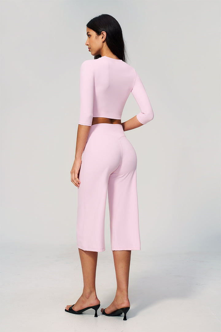 Light pink two-piece set with long-sleeve cropped top and wide-leg capri pants, back view