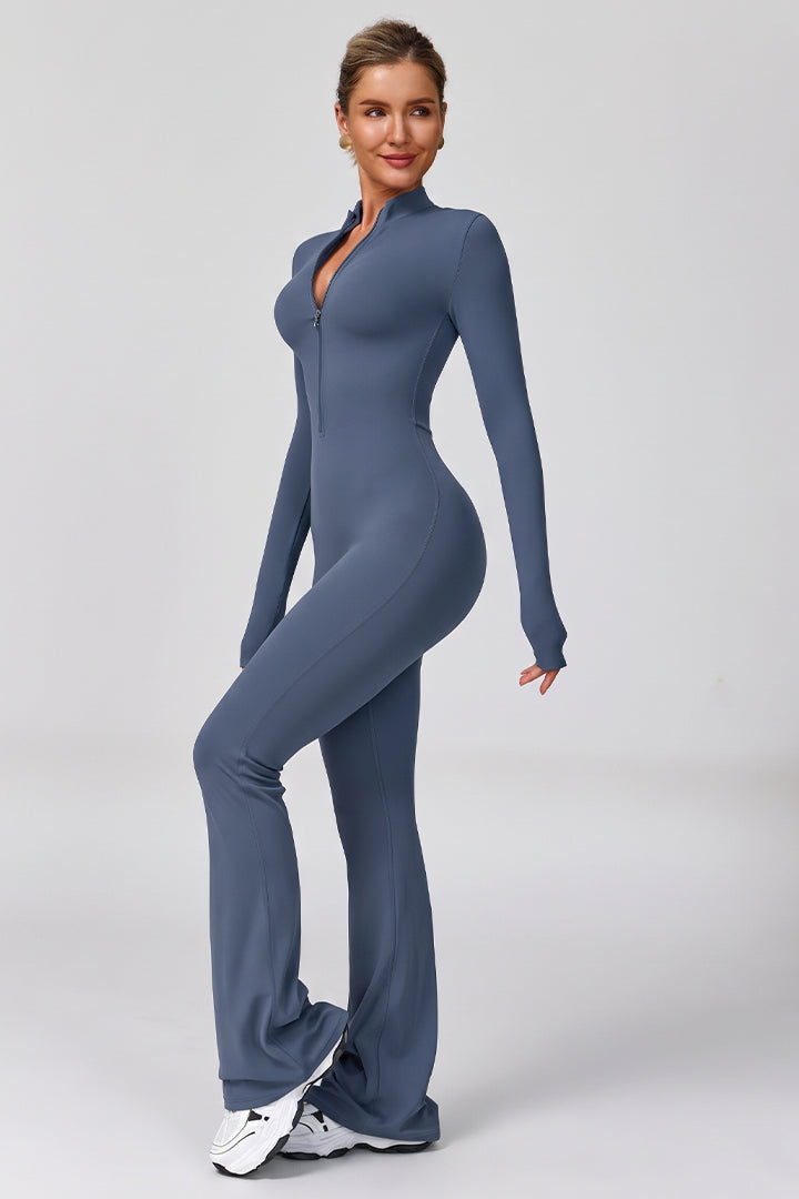 Blue women's long-sleeve sports jumpsuit with front zipper, fitted torso and bell legs